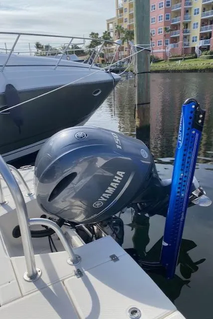 Slide: The Image of 2016 Robalo 226 Cayman with Yamaha outboard motor docked near colorful buildings. - 9
