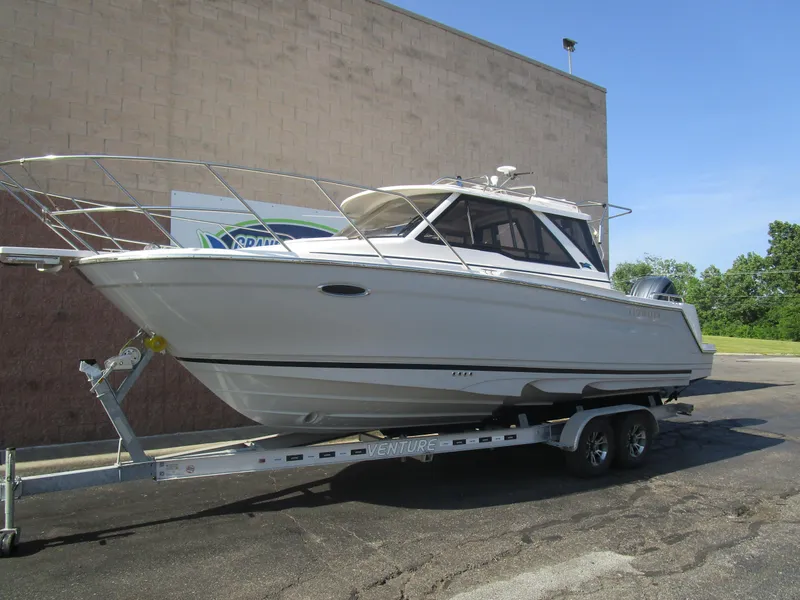Slide: The Image of 2025 Cutwater C-248 Coupe boat on trailer, parked outdoors. - 1