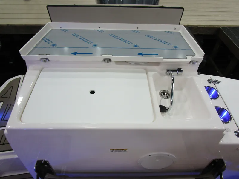 Slide: The Image of 2025 Cutwater C-248 Coupe boat deck with storage compartment and sink. - 12