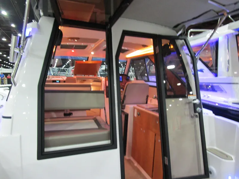 Slide: The Image of 2025 Cutwater C-248 Coupe interior with modern seating and kitchenette. - 17