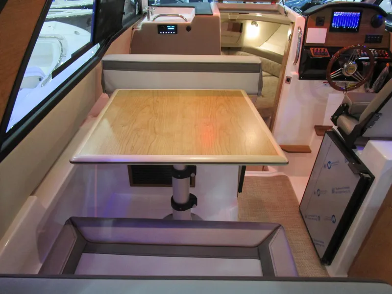 Slide: The Image of Interior of 2025 Cutwater C-248 Coupe featuring a dining area and helm station. - 18