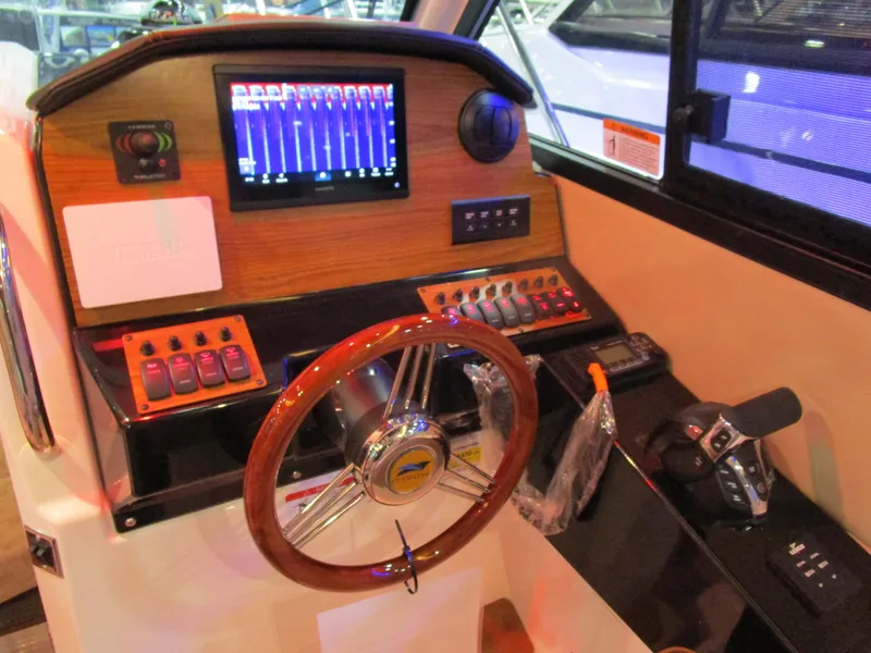 Slide: The Image of 2025 Cutwater C-248 Coupe helm with modern controls and navigation display. - 24
