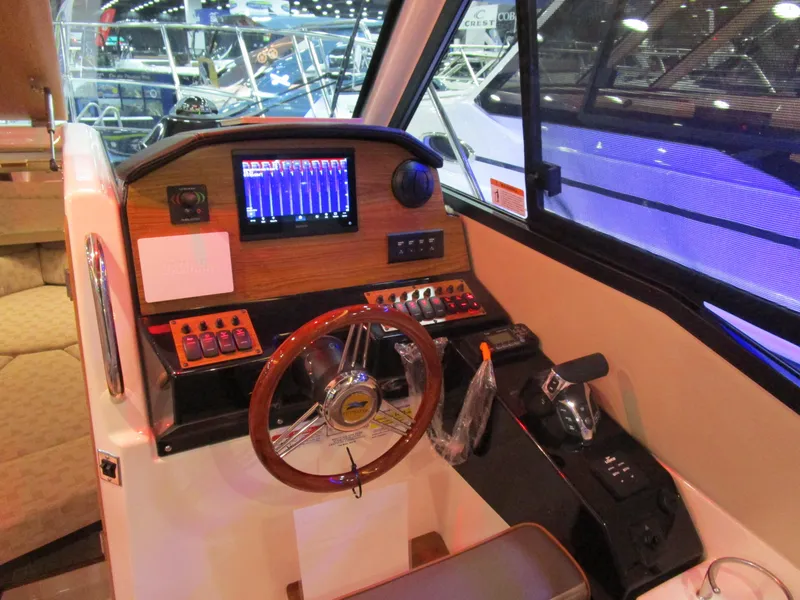 Slide: The Image of 2025 Cutwater C-248 Coupe helm with modern controls and navigation display. - 26