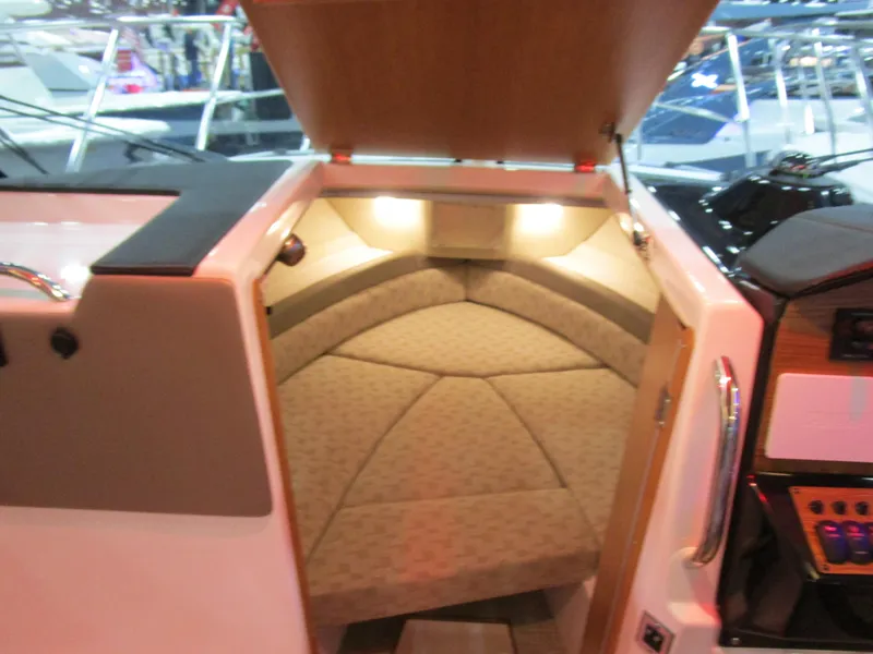 Slide: The Image of 2025 Cutwater C-248 Coupe interior cabin with cushioned seating and ambient lighting. - 27