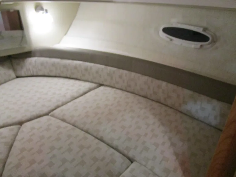 Slide: The Image of 2025 Cutwater C-248 Coupe interior cabin with cushioned seating and porthole window. - 29