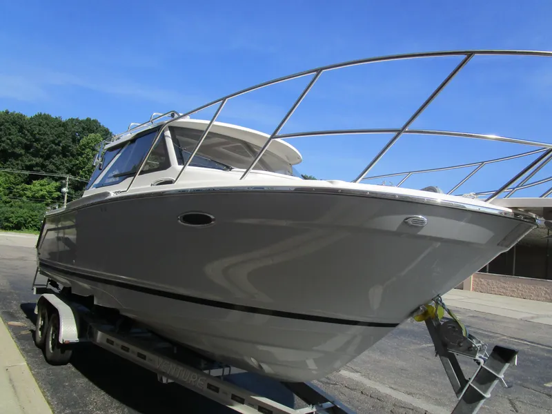 Slide: The Image of 2025 Cutwater C-248 Coupe boat on trailer under clear blue sky. - 3