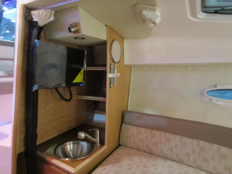 Slide: The Image of Interior of 2025 Cutwater C-248 Coupe featuring compact kitchenette and seating area. - 30