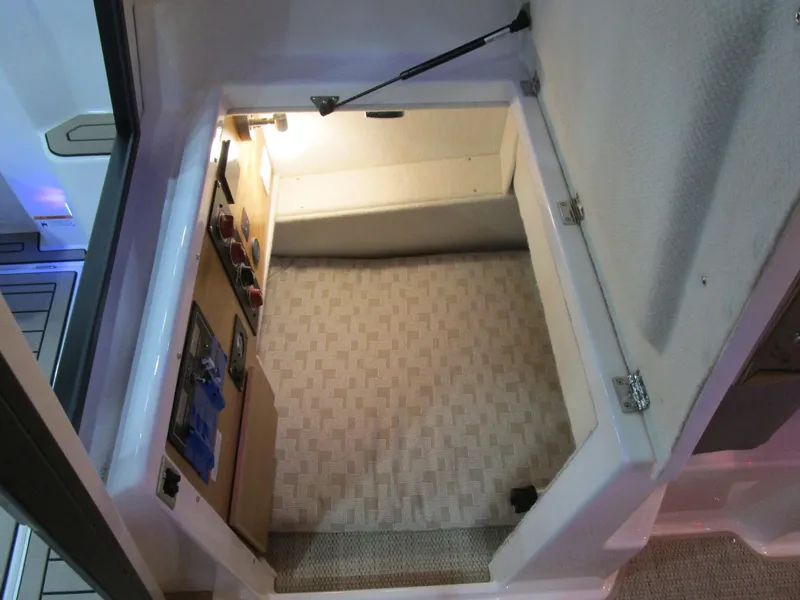 Slide: The Image of 2025 Cutwater C-248 Coupe interior storage compartment with light and carpeted floor. - 34