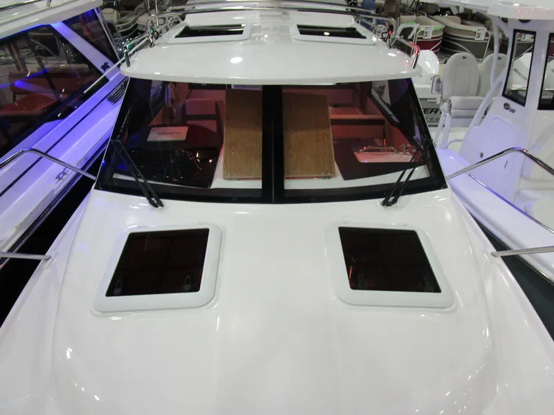 Slide: The Image of 2025 Cutwater C-248 Coupe boat with sleek design and spacious cabin windows. - 42