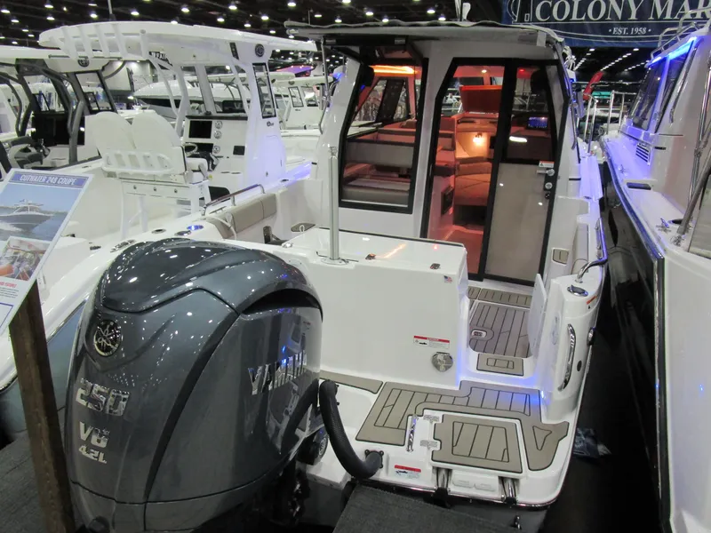 Slide: The Image of 2025 Cutwater C-248 Coupe boat with Yamaha V6 engine at a boat show. - 6