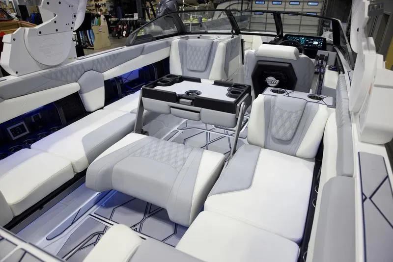 Slide: The Image of 2025 Malibu M242 boat interior with luxurious seating and modern dashboard design. - 20
