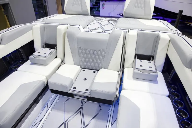 Slide: The Image of 2025 Malibu M242 boat interior with modern seating and sleek design. - 24