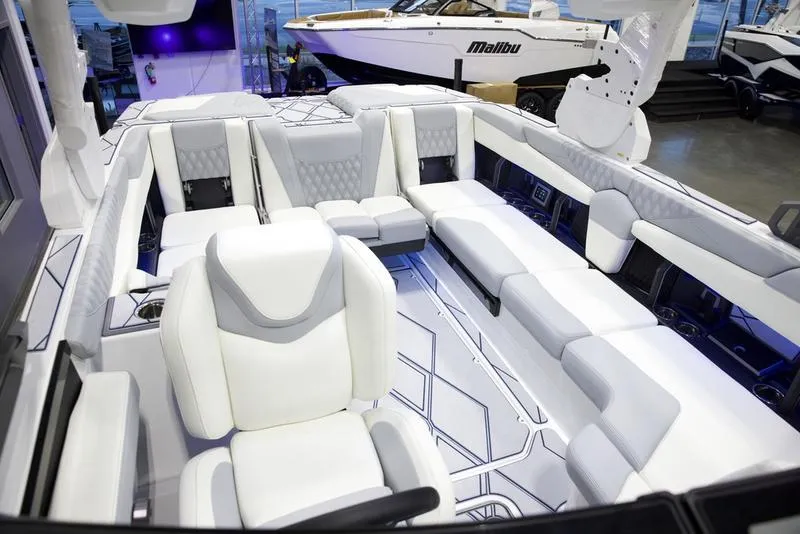 Slide: The Image of 2025 Malibu M242 boat interior with luxurious white seating and modern design. - 26