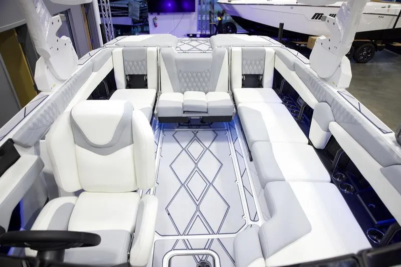 Slide: The Image of Luxurious interior of 2025 Malibu M242 boat with white seating and modern design. - 27