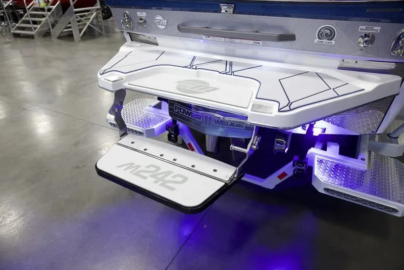 Slide: The Image of 2025 Malibu M242 boat with illuminated swim platform and sleek design. - 7