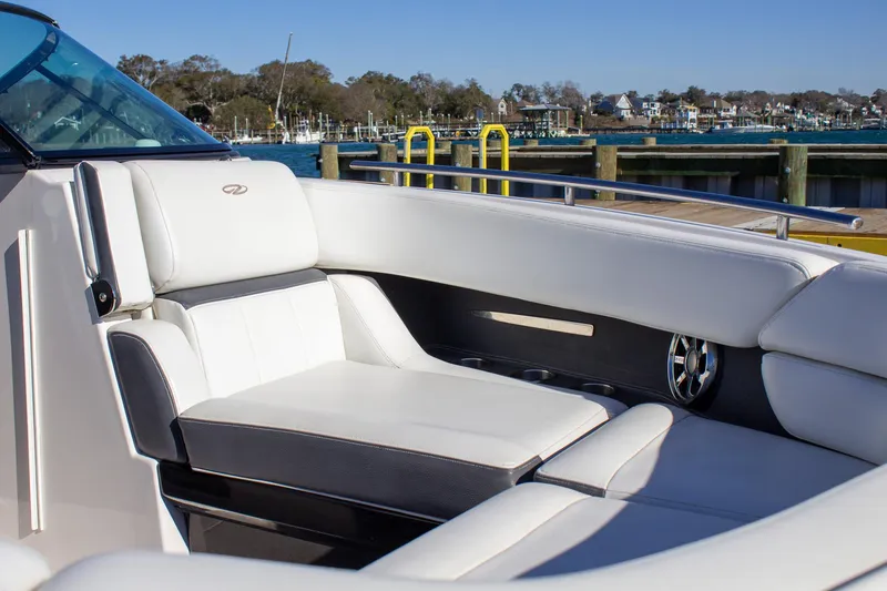 Slide: The Image of 2015 Regal 2800 boat with luxurious white seating at a marina. - 10