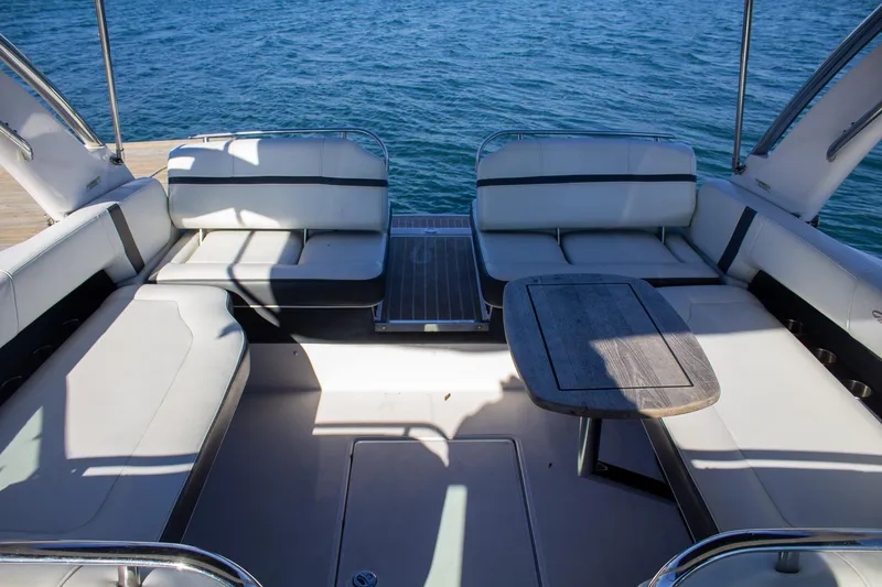 Slide: The Image of Interior of 2015 Regal 2800 boat with seating and table, overlooking blue water. - 22