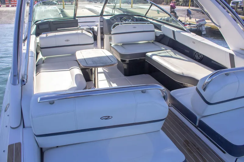 Slide: The Image of 2015 Regal 2800 boat interior with white seating and wooden flooring. - 23