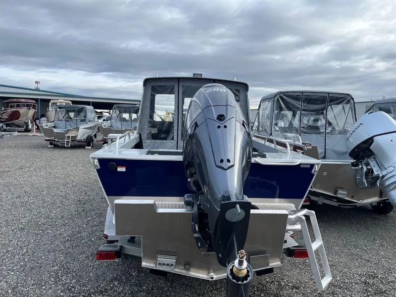 Slide: The Image of 2024 Hewescraft 200 ProV ET HT boat with outboard motor, parked in a lot. - 3