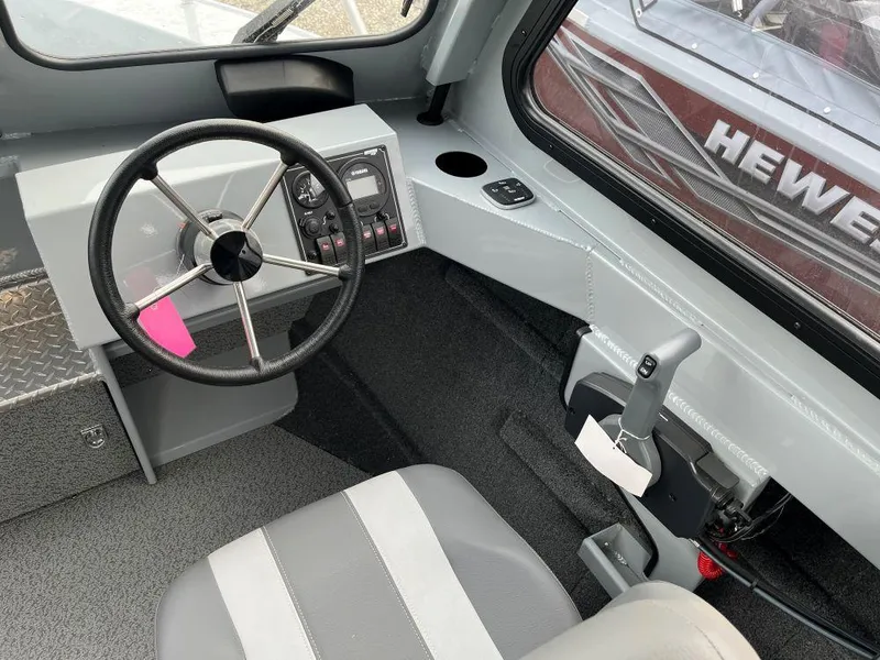 Slide: The Image of Interior of 2024 Hewescraft 200 ProV ET HT boat, featuring steering wheel and controls. - 6