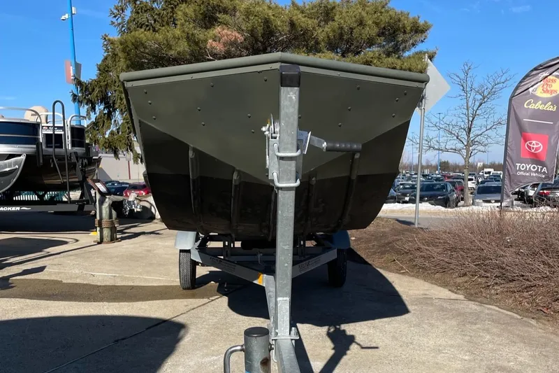 Slide: The Image of 2021 Lowe 1648 Jon boat on trailer, parked outdoors, sunny day. - 5