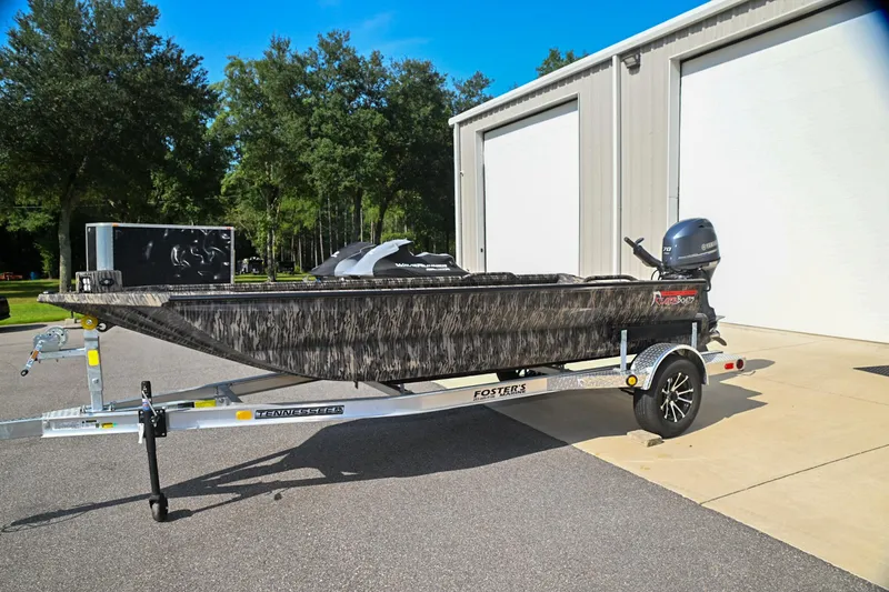 Slide: The Image of 2024 Reaper Boats TIMBER REAPER 756 on trailer, parked outside a building. - 1