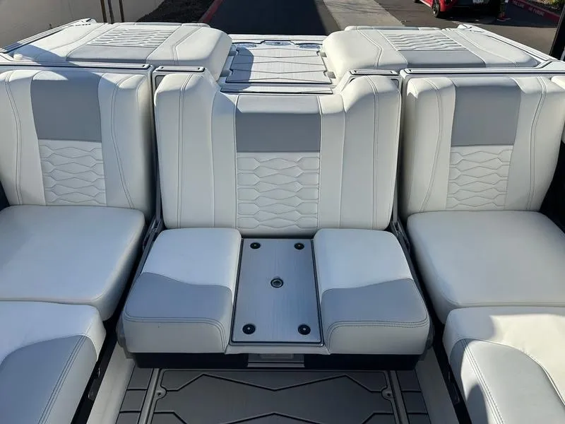 Slide: The Image of 2025 Malibu 24 MXZ boat interior with luxurious white seating. - 18