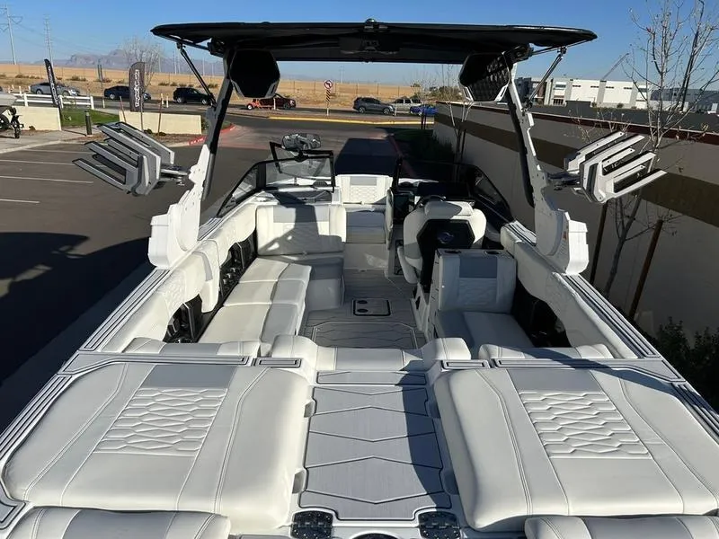 Slide: The Image of 2025 Malibu 24 MXZ boat with spacious white interior and modern design. - 9