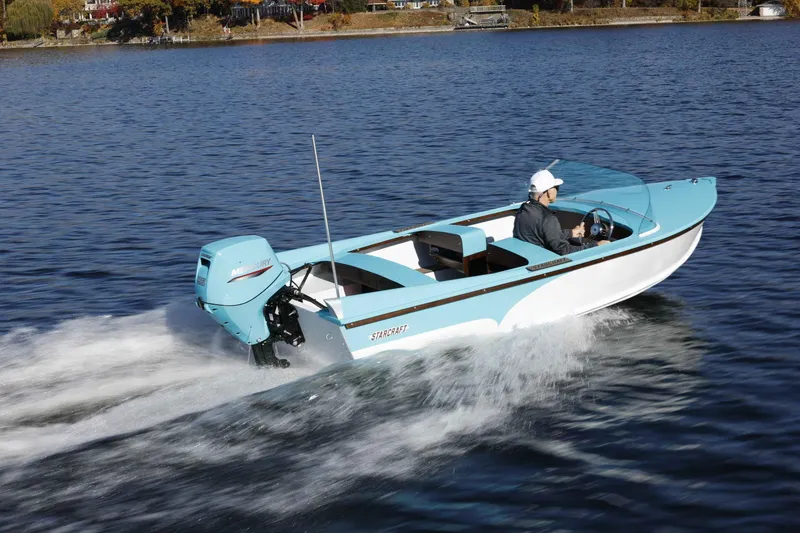 Slide: The Image of 2025 Starcraft 57 SKI CHAMP boat cruising on a lake with a Mercury engine. - 3