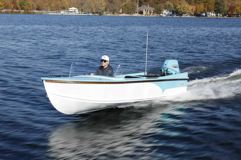 Slide: The Image of 2025 Starcraft 57 SKI CHAMP boat cruising on a lake with autumn foliage in the background. - 3
