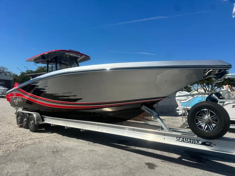 Slide: The Image of 2021 Fountain 38SC boat on trailer under clear blue sky. - 0