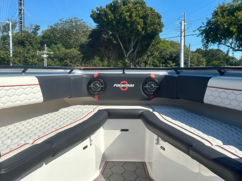 Slide: The Image of 2021 Fountain 38SC boat interior with cushioned seating and speakers. - 10