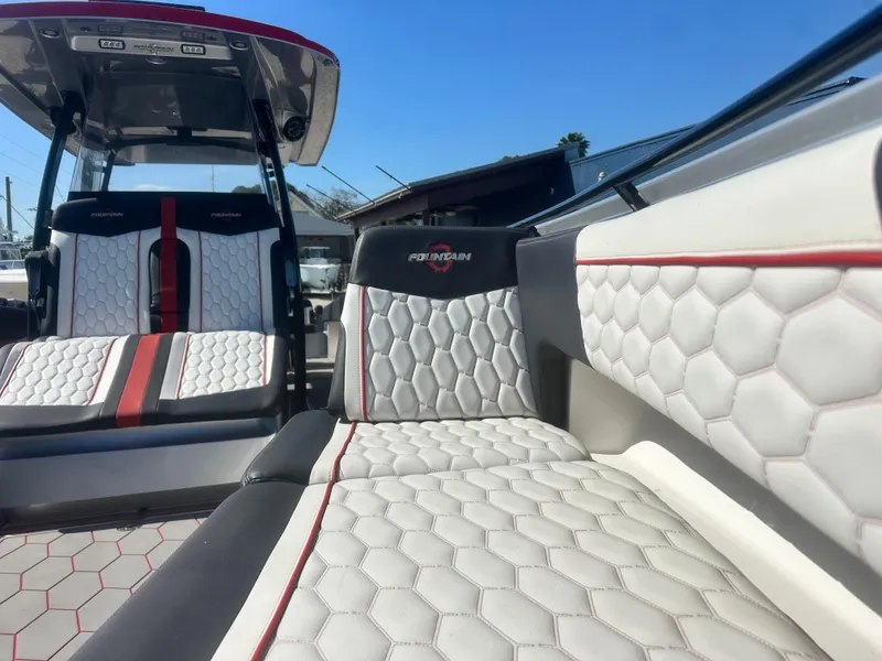 Slide: The Image of 2021 Fountain 38SC boat interior with hexagonal-patterned seating and red accents. - 12