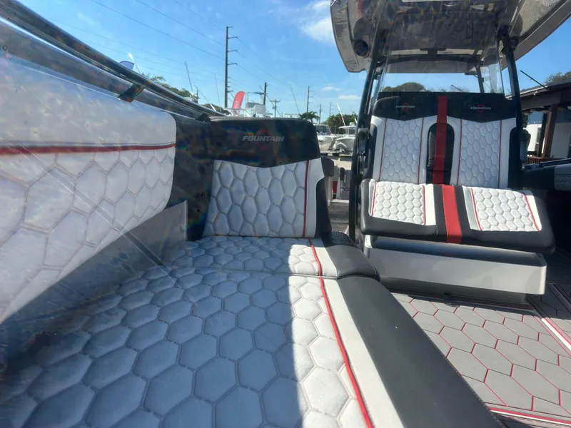 Slide: The Image of 2021 Fountain 38SC boat interior with hexagonal-patterned seating and red accents. - 13