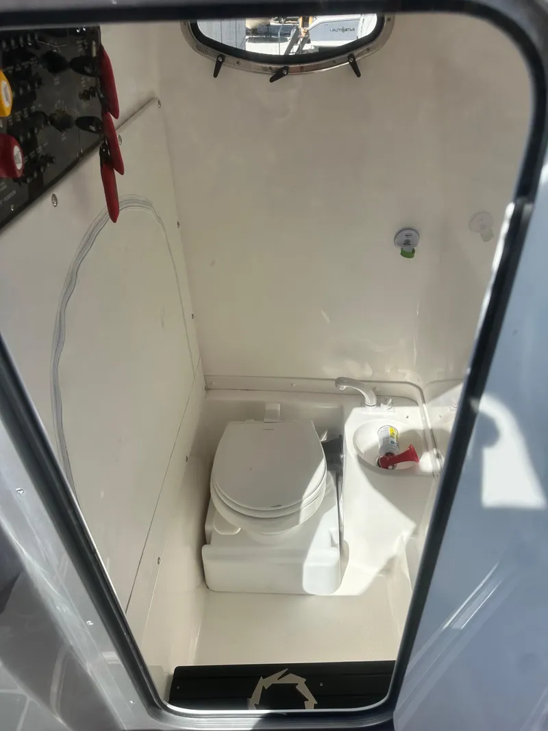 Slide: The Image of 2021 Fountain 38SC boat interior bathroom with toilet and sink. - 17