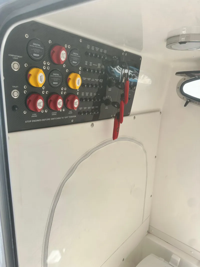 Slide: The Image of Control panel inside 2021 Fountain 38SC boat, featuring switches and dials. - 18