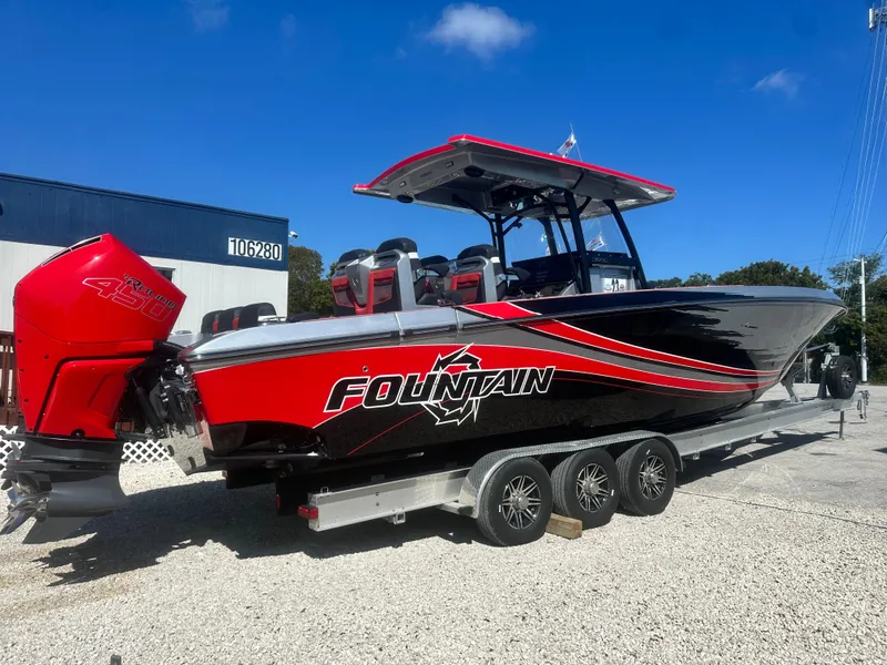 Slide: The Image of 2021 Fountain 38SC boat with red and black design on a trailer. - 2
