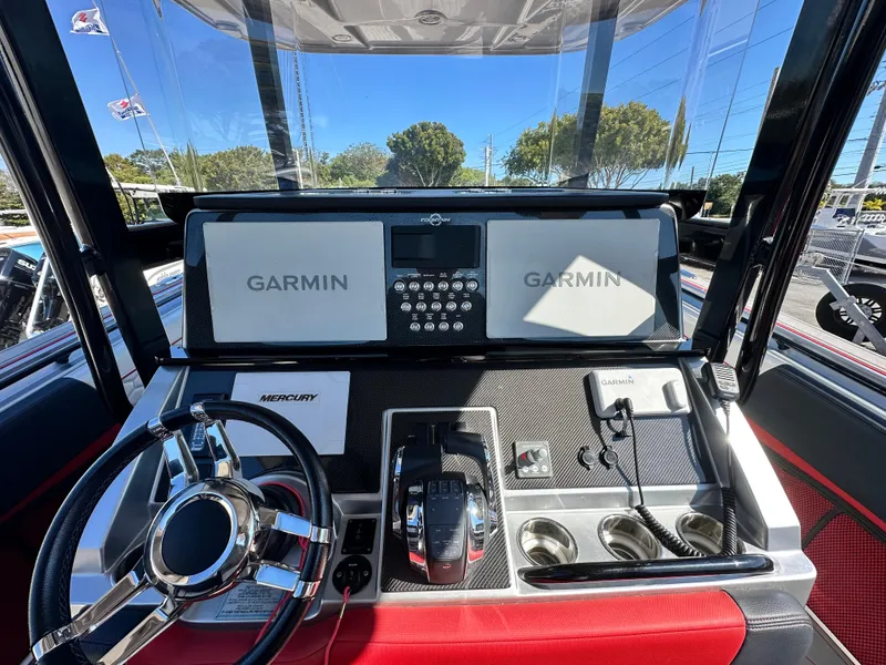 Slide: The Image of Control panel of 2021 Fountain 38SC boat with Garmin displays and Mercury controls. - 25