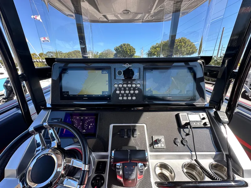 Slide: The Image of 2021 Fountain 38SC boat dashboard with dual navigation screens and modern controls. - 26