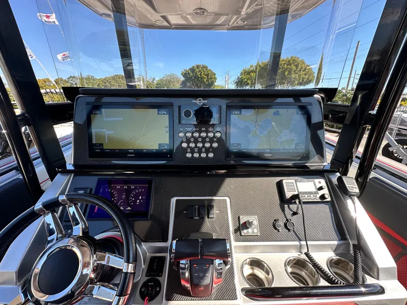Slide: The Image of 2021 Fountain 38SC boat dashboard with navigation screens and controls. - 27