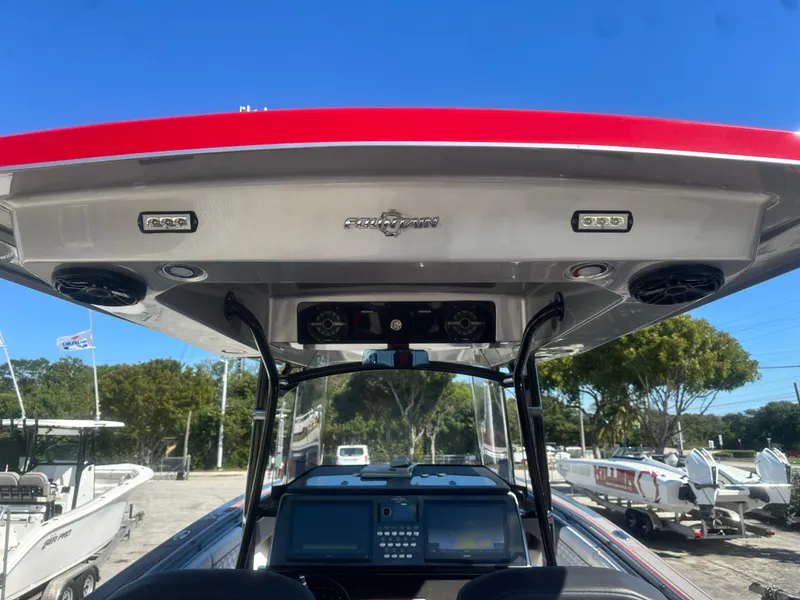 Slide: The Image of 2021 Fountain 38SC boat console with red canopy and advanced navigation system. - 31