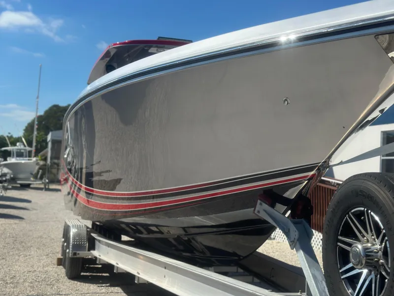 Slide: The Image of 2021 Fountain 38SC boat on trailer, sleek design, sunny day. - 4