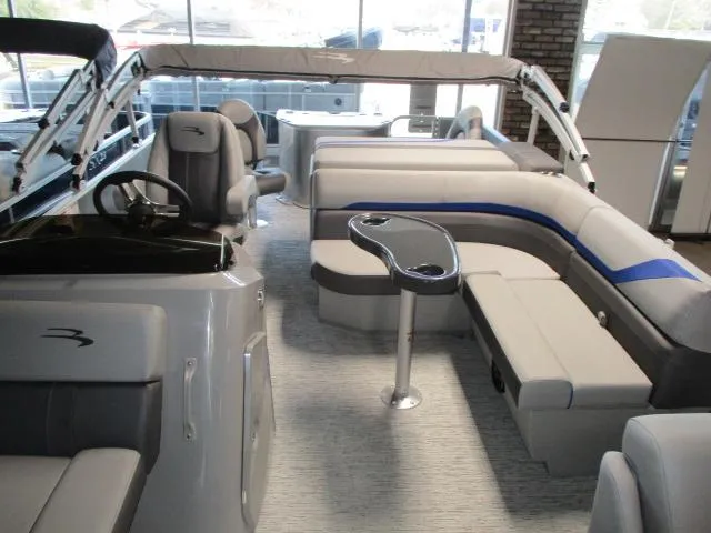 Slide: The Image of 2025 Bennington 23SXS STERN FISH boat interior with plush seating and modern design. - 2