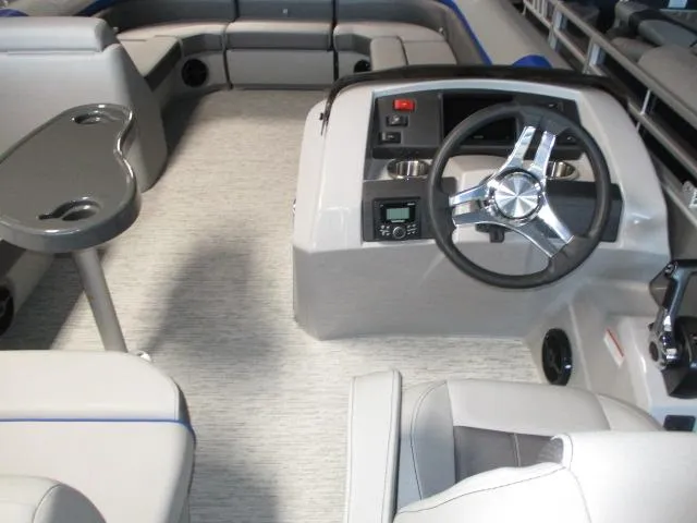 Slide: The Image of 2025 Bennington 23SXS STERN FISH boat interior with steering wheel and seating area. - 4
