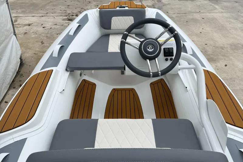 Slide: The Image of 2025 Gala A300Q boat interior with steering wheel and wood accents. - 13
