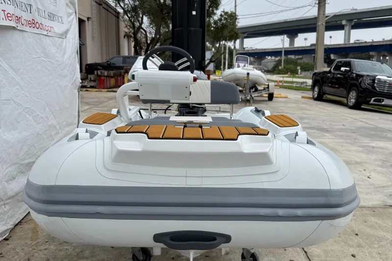 Slide: The Image of 2025 Gala A300Q inflatable boat with wooden accents, parked outdoors. - 6