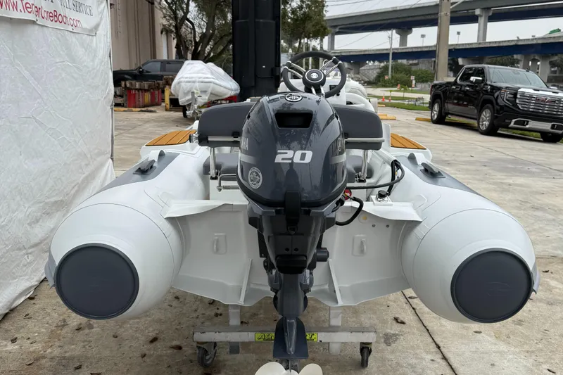 Slide: The Image of 2025 Gala A300Q inflatable boat with 20 HP outboard motor, parked outdoors. - 10