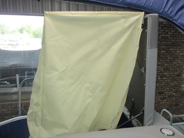 Slide: The Image of 2025 Bennington 20S boat interior with yellow privacy curtain and blue canopy. - 4