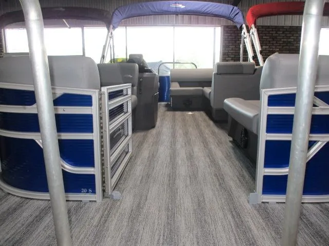 Slide: The Image of 2025 Bennington 20S pontoon boat interior with blue accents and spacious seating. - 9