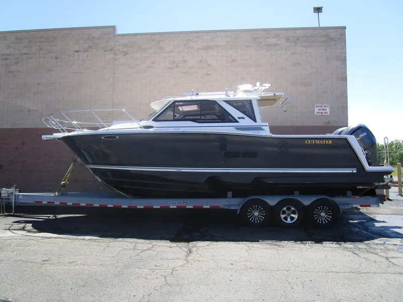 The Image of 2025 Cutwater C-288 Coupe boat on trailer, parked outdoors. - 0